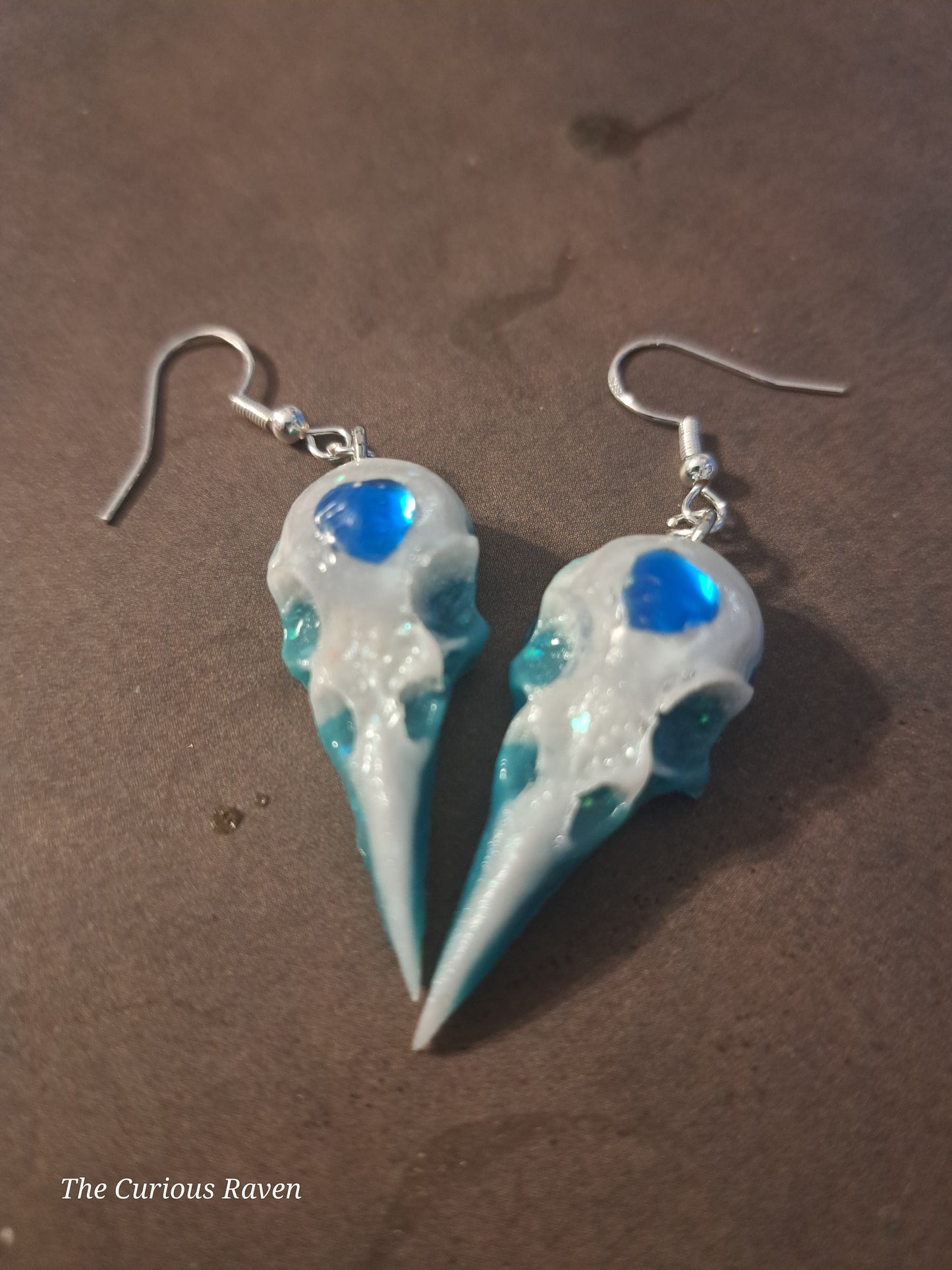 Pearl and Blue Glow in the Dark Resin Raven Skull Earrings