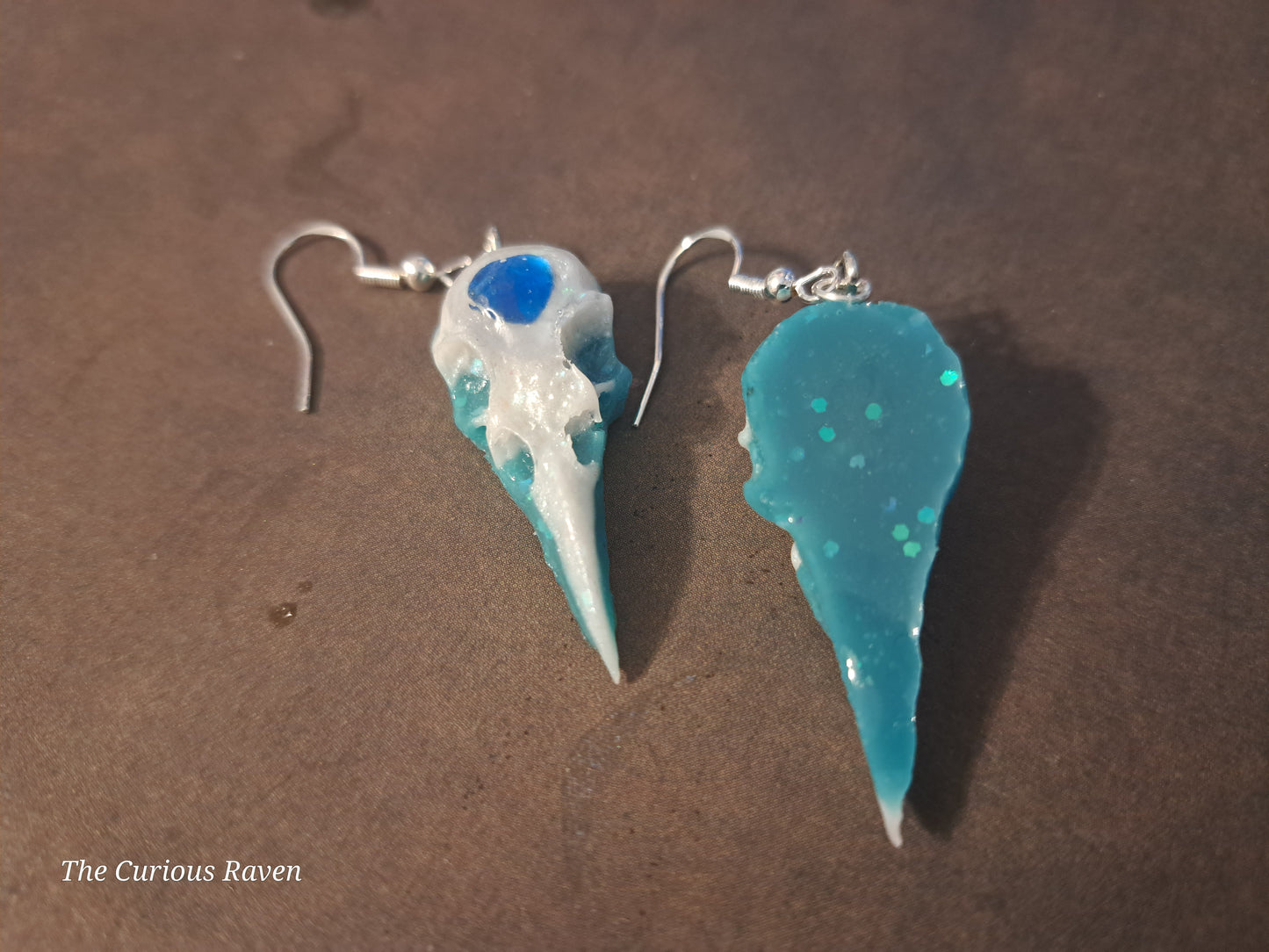 Pearl and Blue Glow in the Dark Resin Raven Skull Earrings