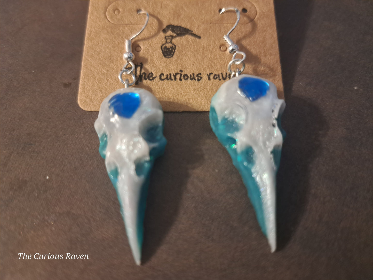 Pearl and Blue Glow in the Dark Resin Raven Skull Earrings